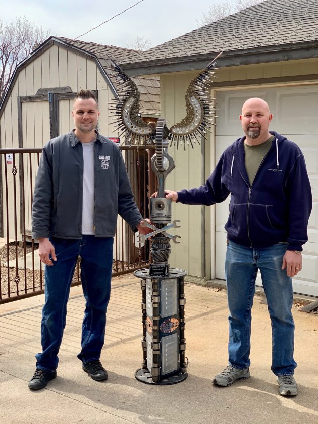 Submitted Photo Clint Burgardt, right, was given a handmade sculpture made out of repurposed parts by his brother Rusty Burgardt, left, in memory of their father-in-law, Mike Hemphill.